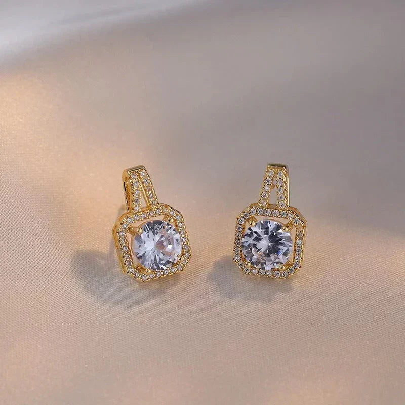 Elegant gold-toned jewelry set including necklace, earrings, and ring with zircon gemstone pendant