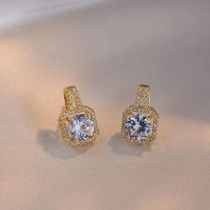 Elegant gold-toned jewelry set including necklace, earrings, and ring with zircon gemstone pendant