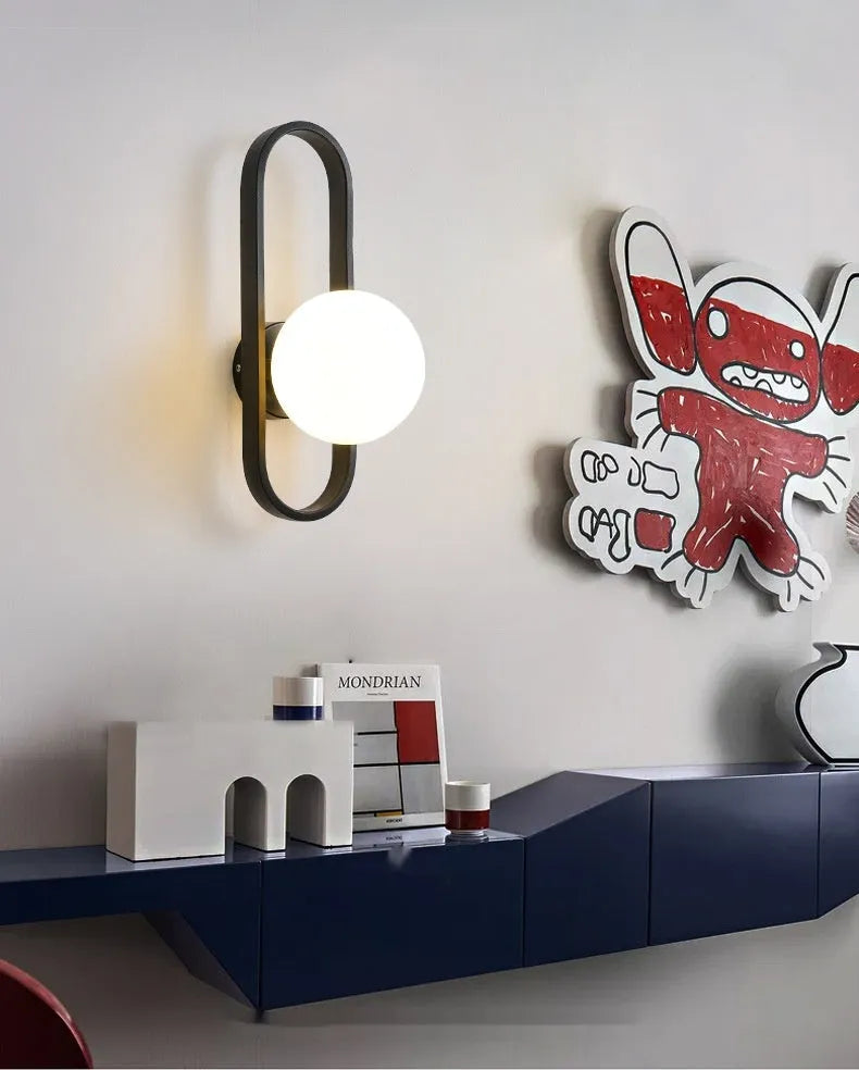 Minimalist wall lamp in black or gold finish with glass shade and 12W tri-colour LED lighting