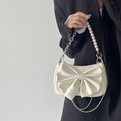 Black and white PU bow handbag with pearl chain, perfect for autumn winter fashion