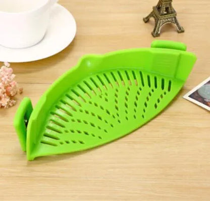 Silicone clip-on kitchen strainer with stainless steel frame attached to pot rim