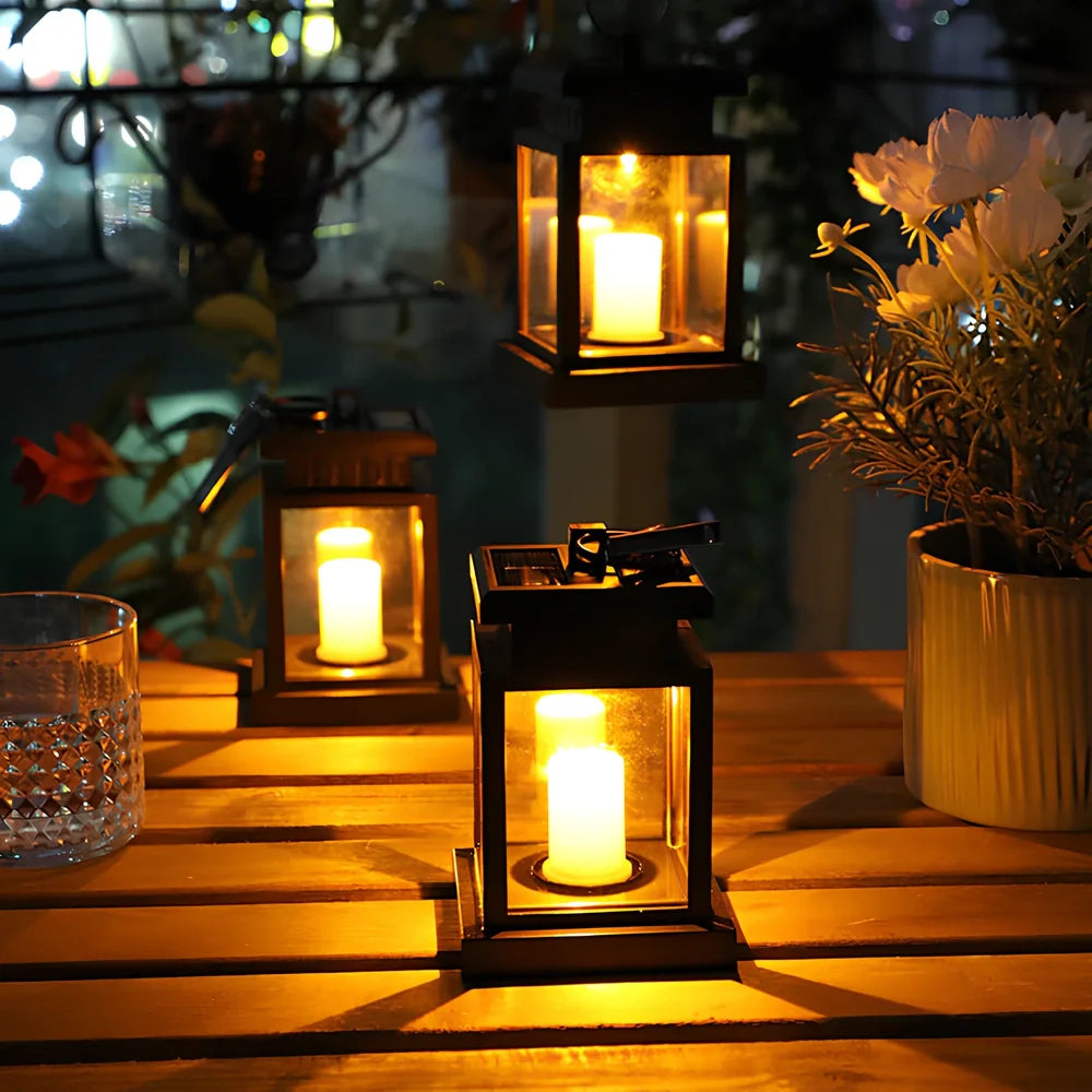 Black solar candle lamp with warm white LED illumination for outdoor gardens and patios