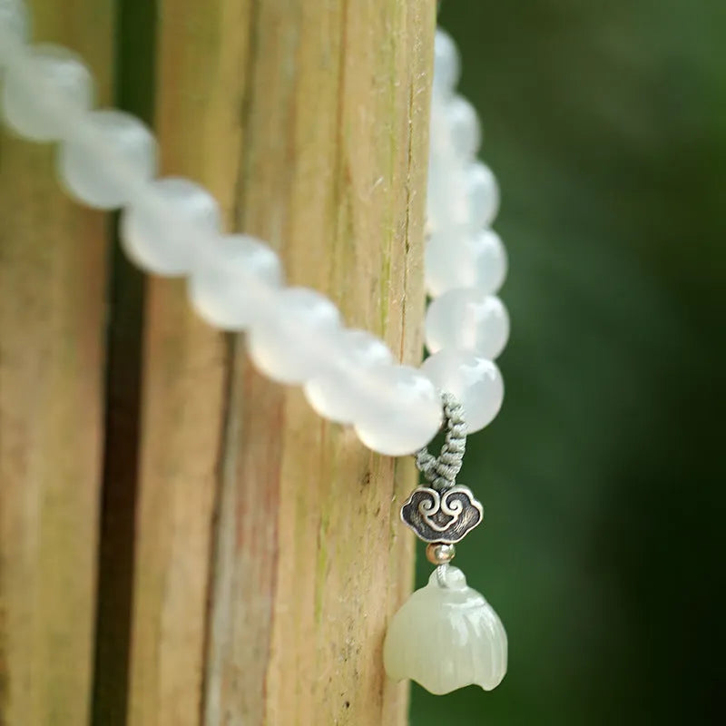 Women's bracelet featuring a niche design in S925 sterling silver with white agate and Hetian jade elements in a lotus-inspired geometric national style pattern, crafted for those seeking distinctive handcrafted jewellery with cultural motifs