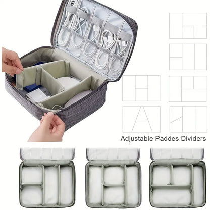 Black travel cable organiser bag open, showing mesh pockets, elastic loops, and removable padded dividers inside.