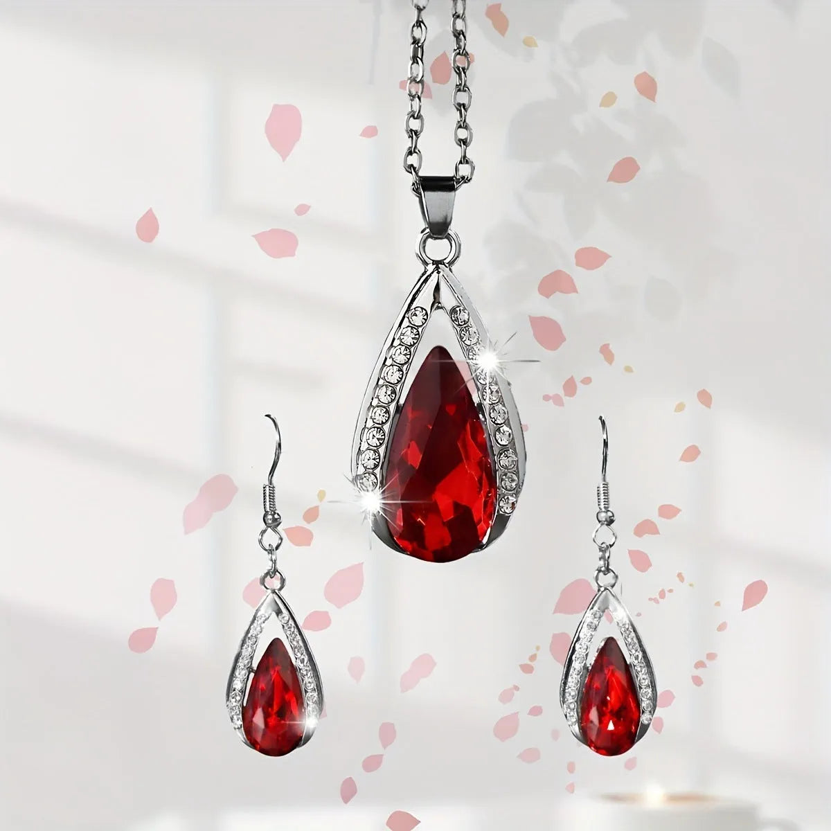 Black red teardrop glass pendant necklace and earrings suite with water droplet design elements on alloy jewellery