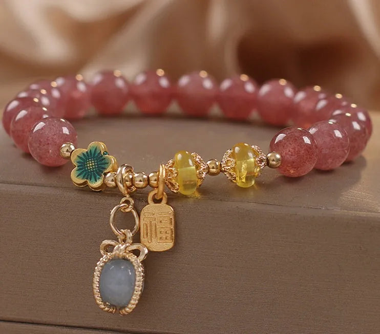 Red women's bracelet with strawberry quartz beads and rhinestones on an alloy chain.