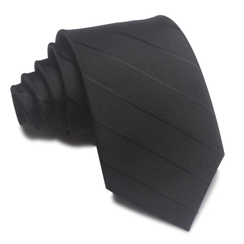 Close-up of a red and black striped jacquard weave tie with an arrow tip, showing texture.
