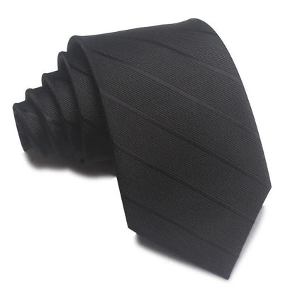 Close-up of a red and black striped jacquard weave tie with an arrow tip, showing texture.