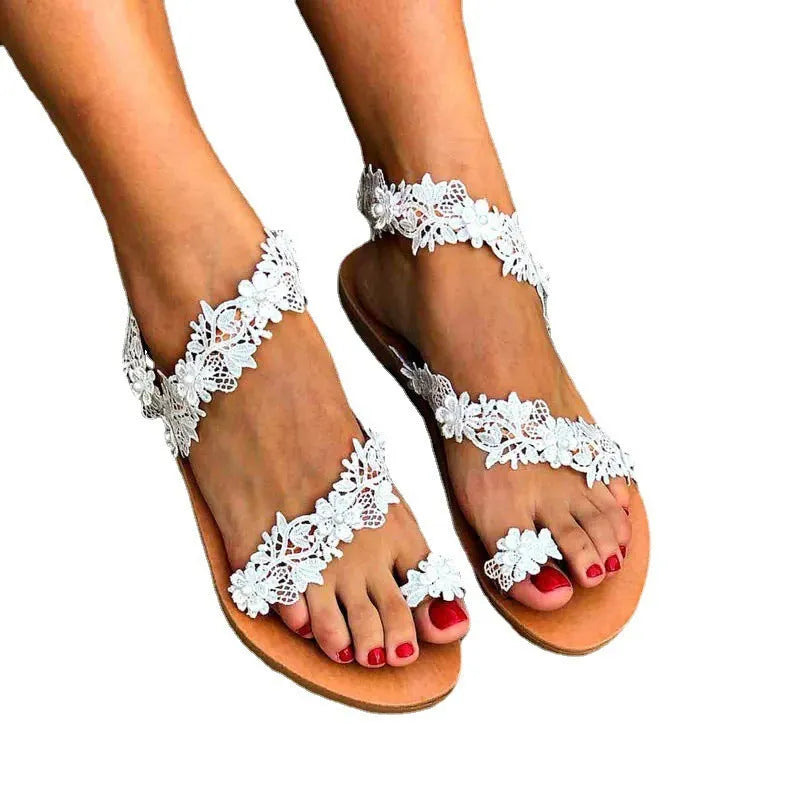 White women's flat slingback shoes with rhinestone and flower decoration on glossy PU upper.