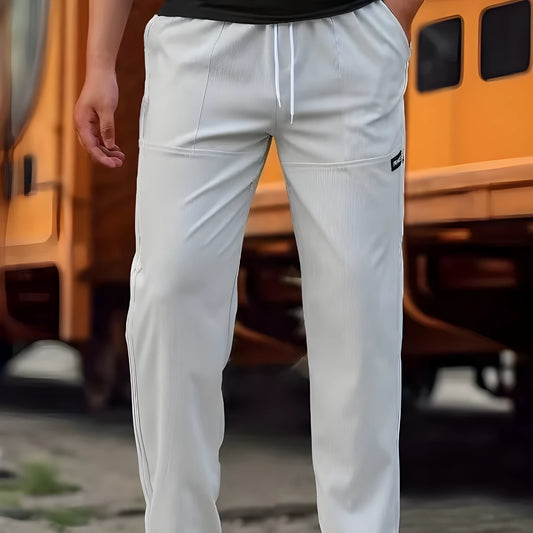 Men's polyester trousers for spring and autumn in light grey, shown in a casual setting