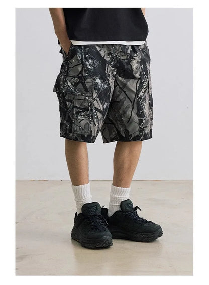 Loose straight-leg denim shorts for teenagers in army green, showing elastic waistband and zip fly.