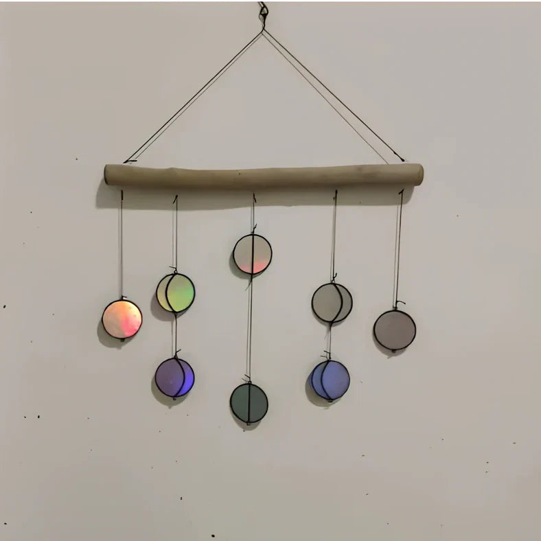 Rainbow coloured moon phase wall decoration with circular iron framework and hanging chain