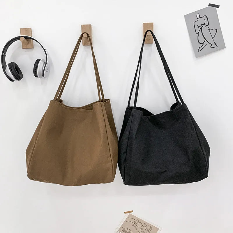Solid colour women's canvas handbag with double shoulder straps showing internal mobile phone compartment