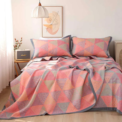 Three-piece cotton gauze bed set with floral print, showing blanket and pillowcases on a bed.
