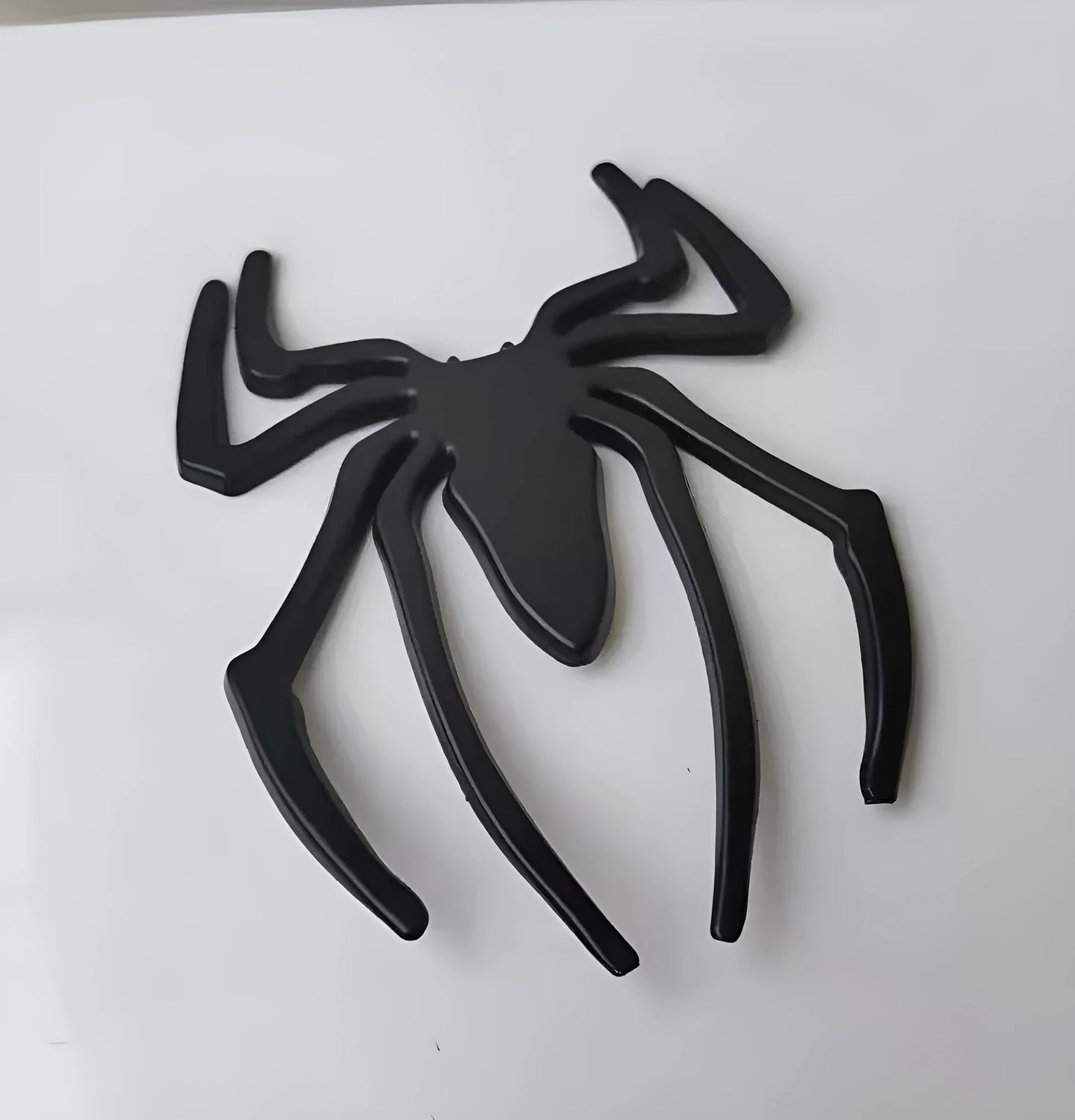 Three-dimensional metal spider bumper sticker in zinc alloy measuring 7cm by 5cm