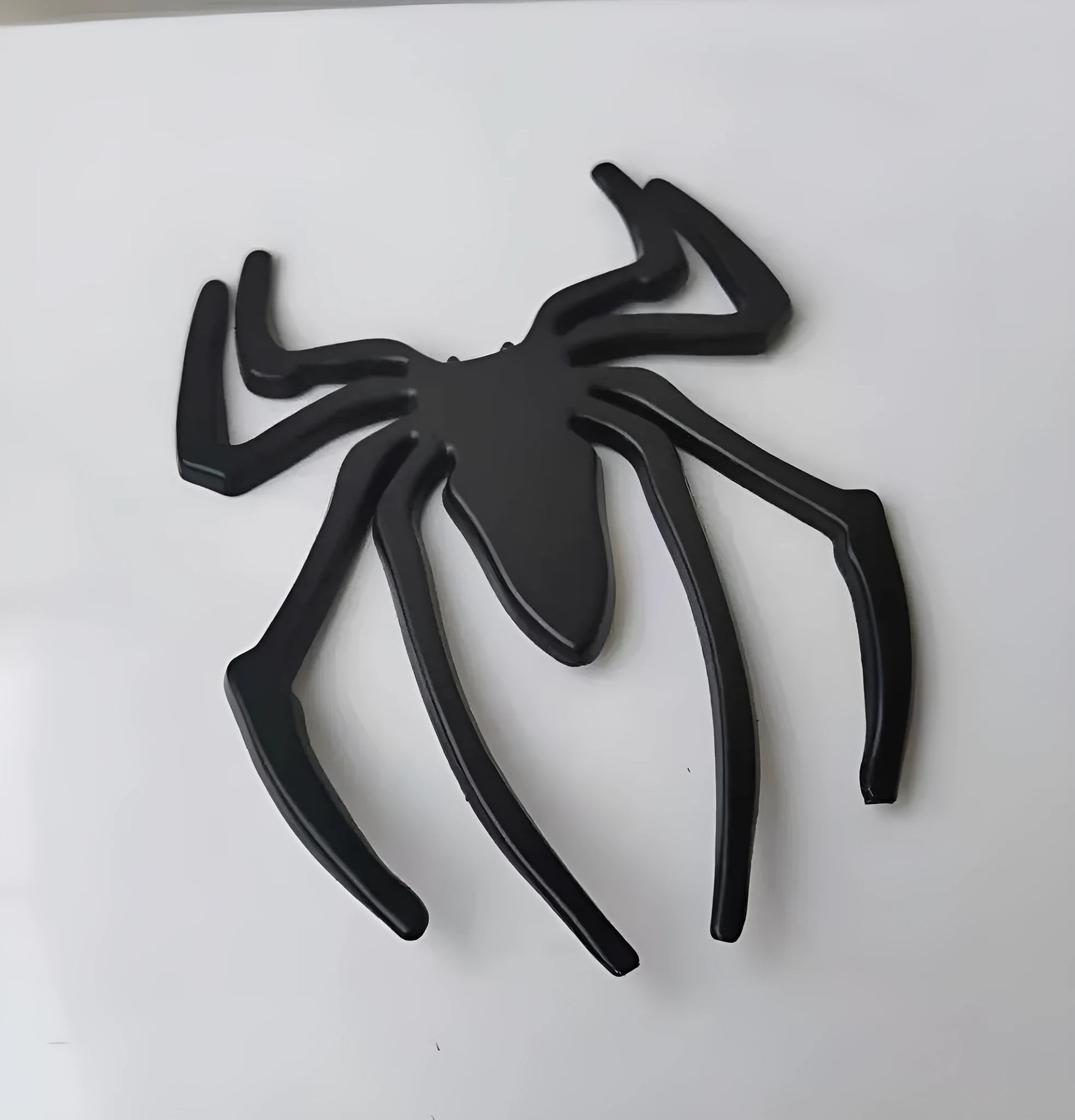 Three-dimensional metal spider bumper sticker in zinc alloy measuring 7cm by 5cm