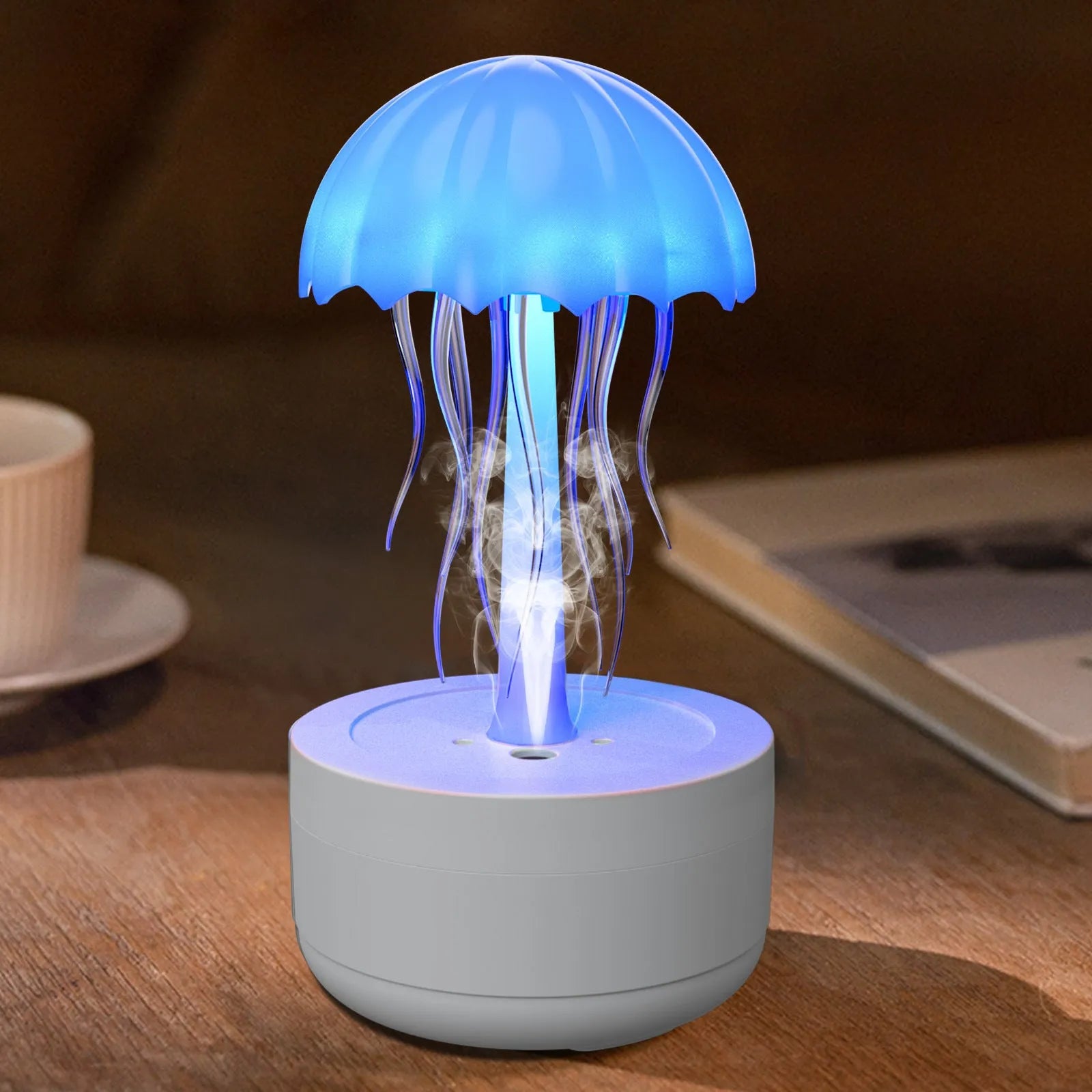 White resin jellyfish humidifier and essential oil diffuser with colourful night light on a desktop.
