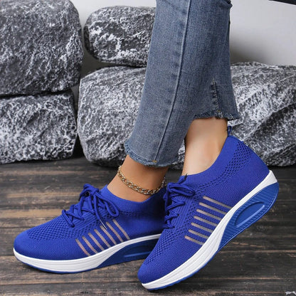 Women's red platform sneakers with mesh upper and front lace-up design on rubber sole