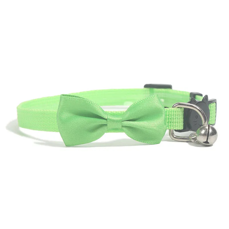 Striped nylon cat collar with decorative bow and bell in multiple colour options on a white background.