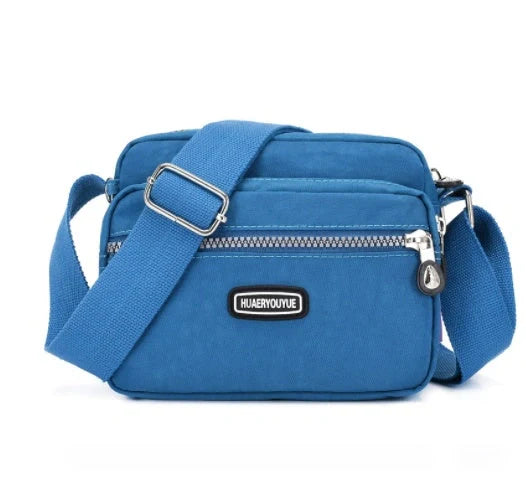 Compact nylon messenger bag in various colors with multiple compartments
