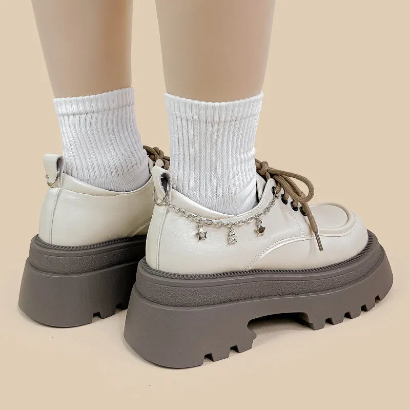 White women's platform Mary Jane shoes with a round toe and thick chunky heel.