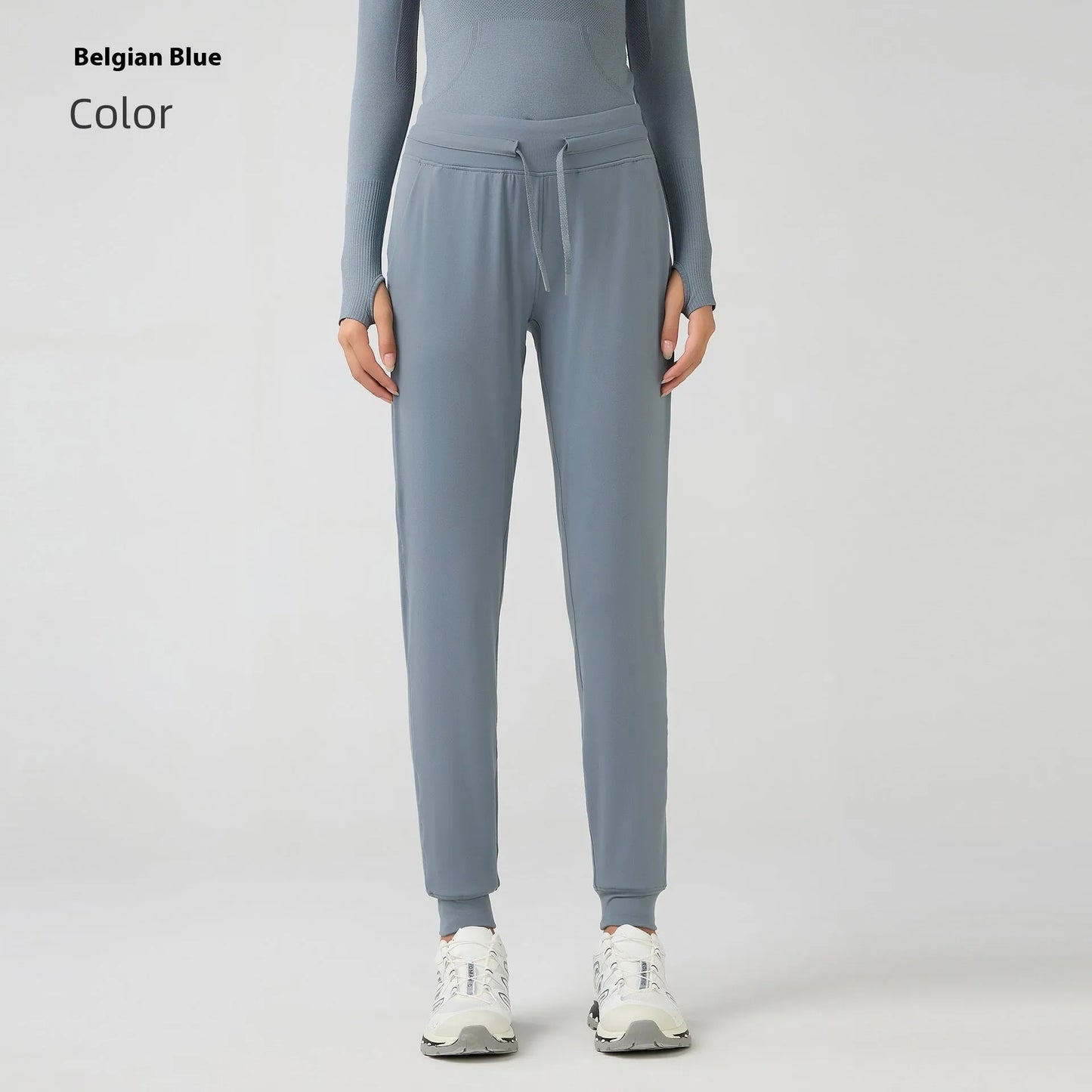Women's high waist yoga pants with drawstring waistband in Belgian blue colour, showing stretch fabric during yoga pose