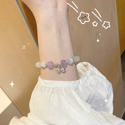 Chinese style glass bead bracelet with bamboo joint design on wrist.