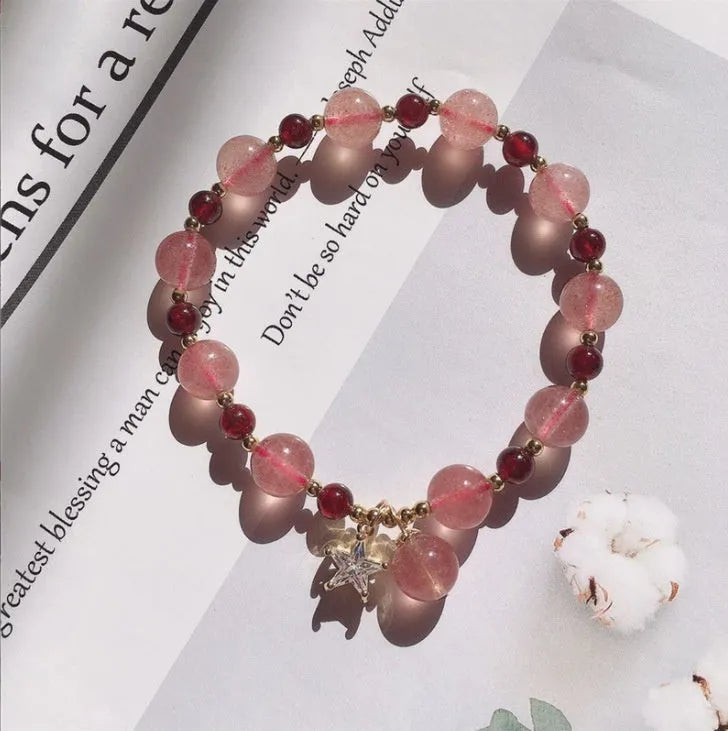 Handcrafted strawberry quartz crystal bracelet with adjustable string closure and Hetian jade peach blossom design