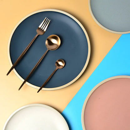 A blue matte-finish 10-inch ceramic dinner plate on a plain surface.