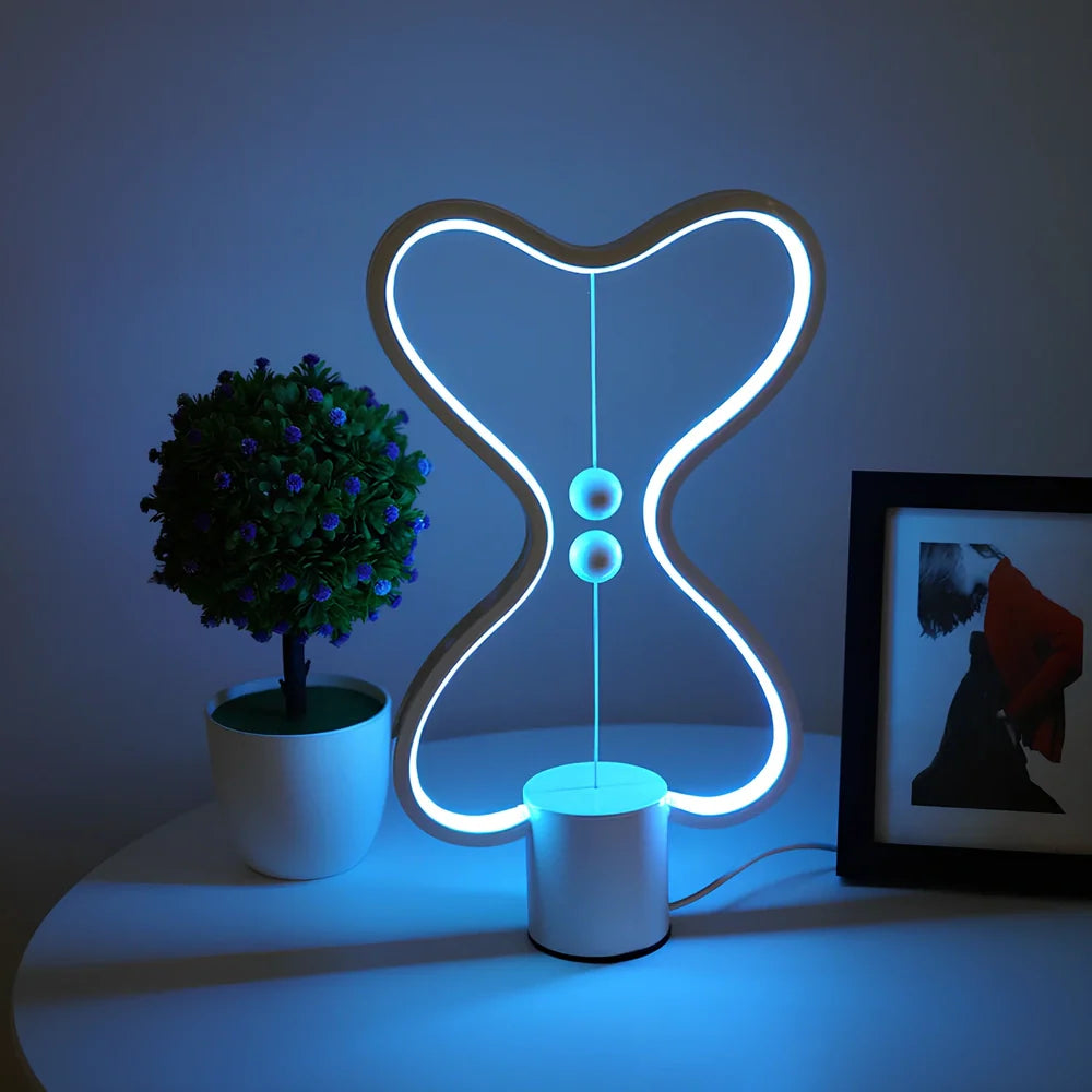 Balance lamp with suspended magnetic netballs and embedded LED lighting in frame