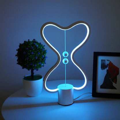 Balance lamp with suspended magnetic netballs and embedded LED lighting in frame