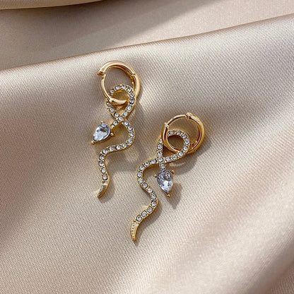 Pair of golden snake-inspired dangle earrings with a captivating and elegant design