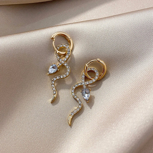 Pair of golden snake-inspired dangle earrings with a captivating and elegant design