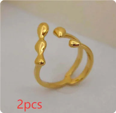 Gold and silver adjustable brass ring featuring a large spherical design on an open shank.