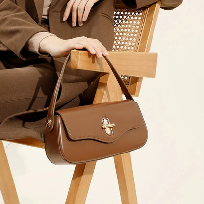 Genuine leather baguette handbag in clamshell design with internal organiser compartments