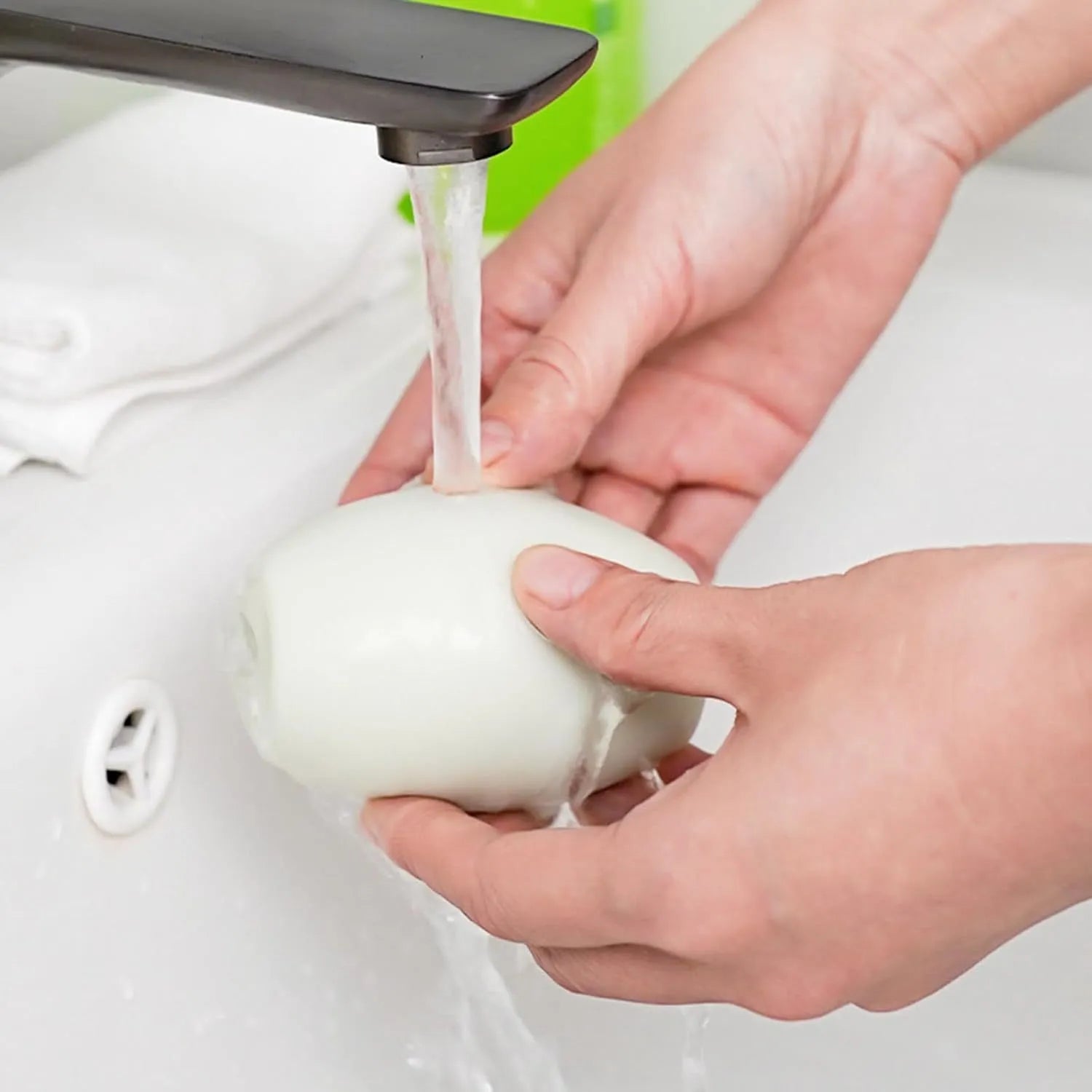 Green and white washable reusable gel lint roller ball for pet hair removal on clothes and furniture