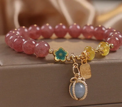 Red women's bracelet with strawberry quartz beads and rhinestones on an alloy chain.