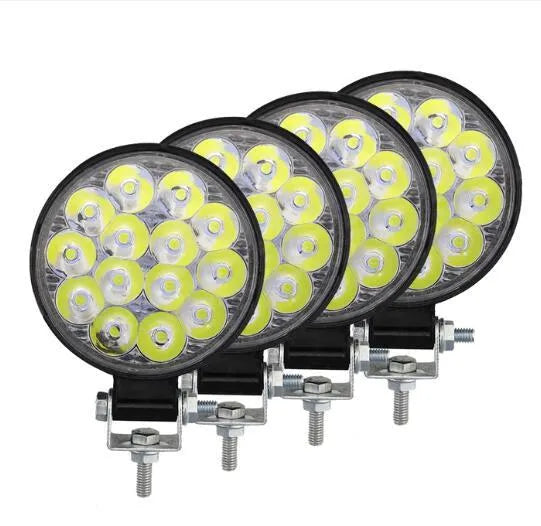 Small round white aluminium LED work light with IP67 rating for automotive use.