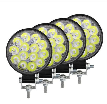Small round white aluminium LED work light with IP67 rating for automotive use.