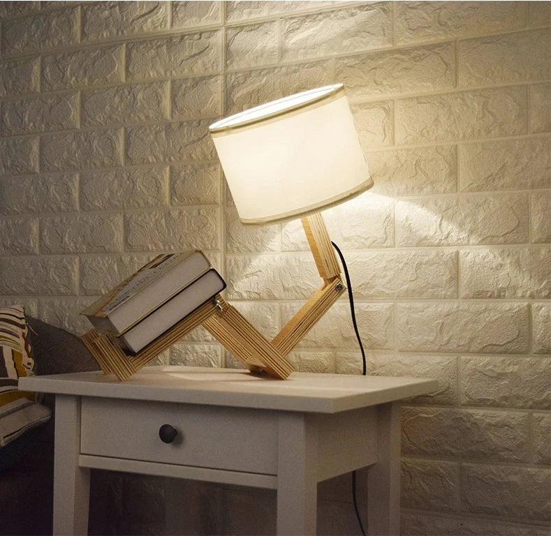 Humanoid wooden table lamp with deformable design and fabric shade for modern home decor