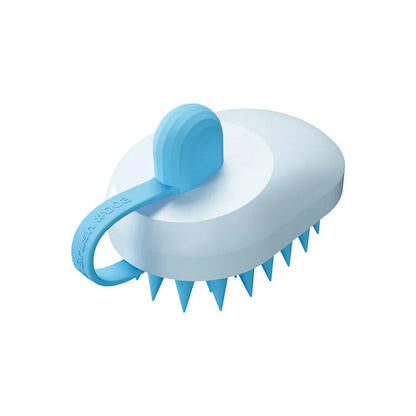 Handheld silicone pet hair remover and massage brush in blue, for use on dogs and cats during bathing.