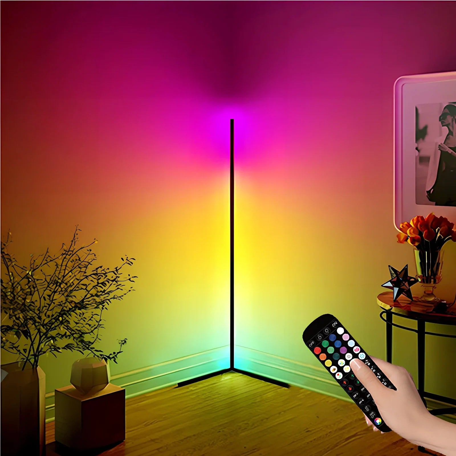 Black smart RGB floor lamp with remote control showing colour-changing illumination in bedroom setting
