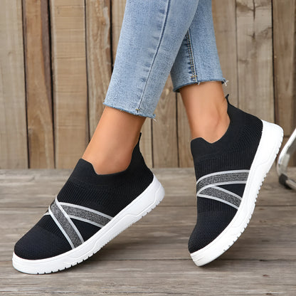 Black women's flyknit mesh flat shoes with rubber sole and tassel detail