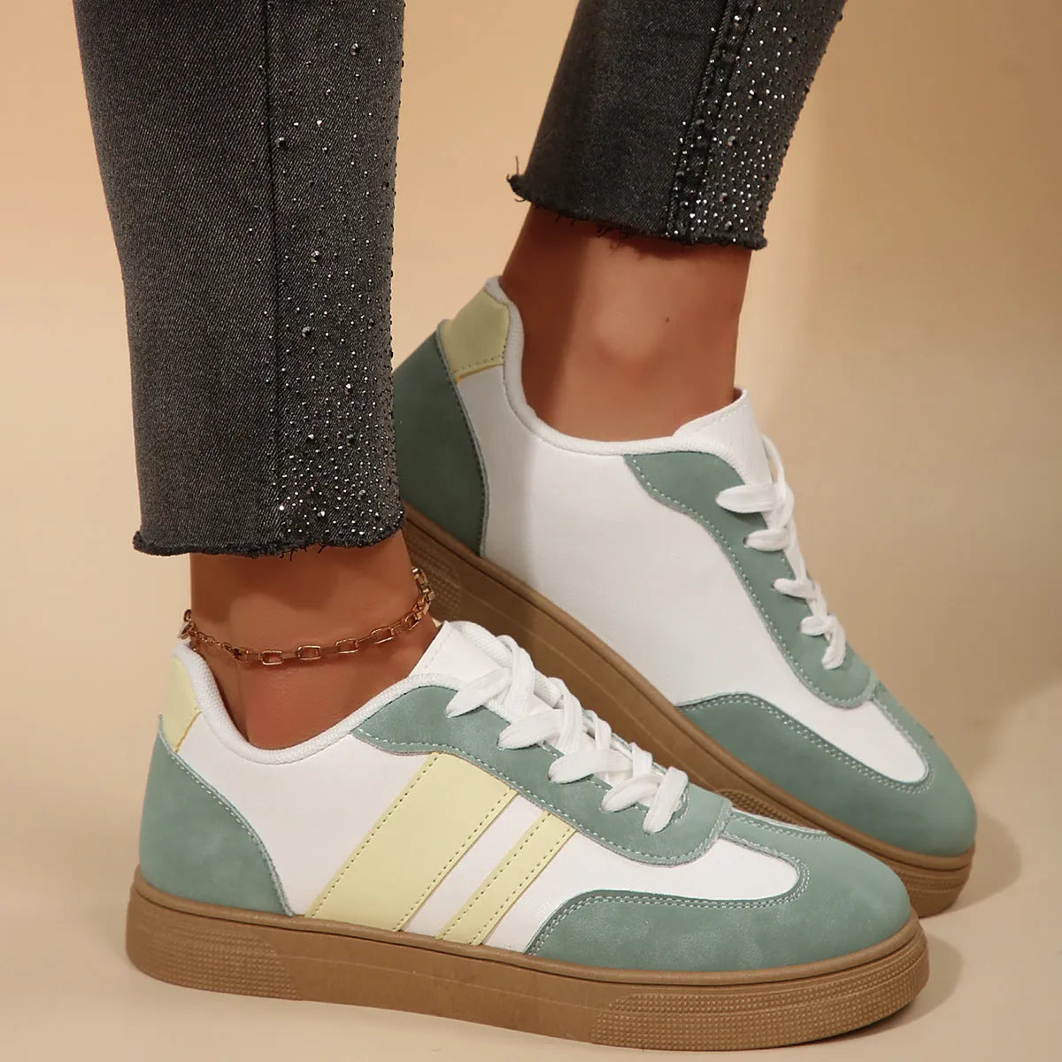 Green women's low-top retro sports shoes with cross-strap design and round toe.