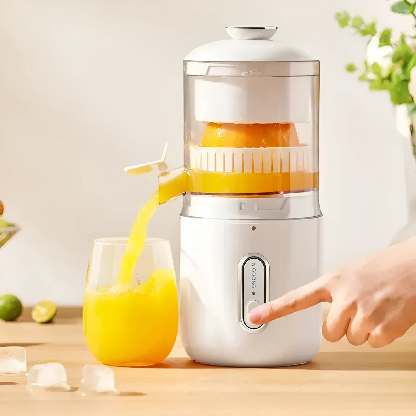 Fresh green portable electric juicer with USB charging cable and orange on a wooden table