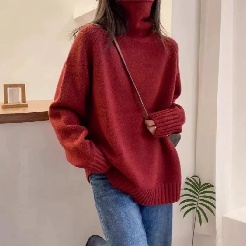 Women's turtleneck sweater in loose fit with thick curling pile collar, available in red, camel, grey, and black colours