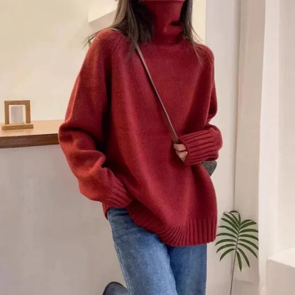 Women's turtleneck sweater in loose fit with thick curling pile collar, available in red, camel, grey, and black colours