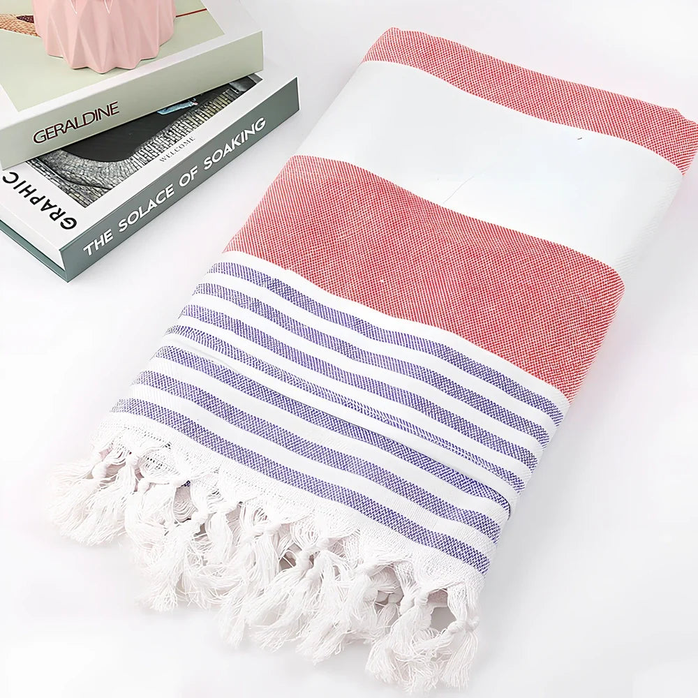 Striped Turkish beach towel showing blue and white pattern, measuring 100cm by 180cm