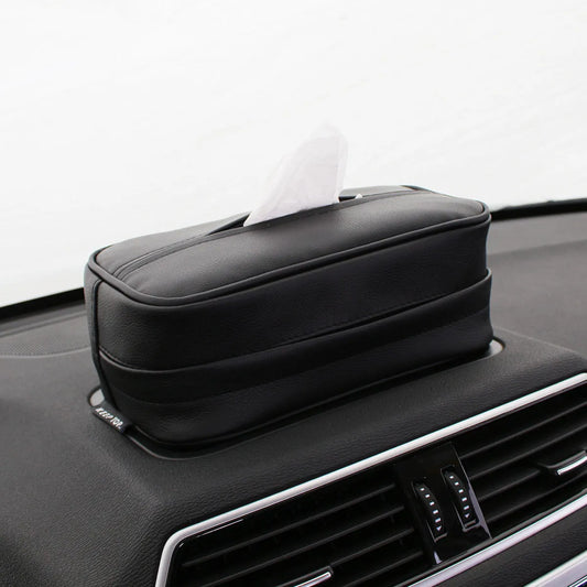 Black leather hanging storage box with PU coating, dimensions 23x13x9cm, shown behind a car headrest