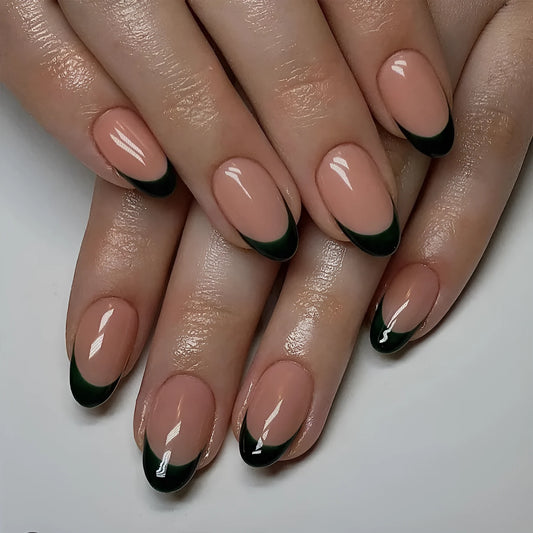 Set of 24 black French style false nails in a short almond shape laid out on a white surface.